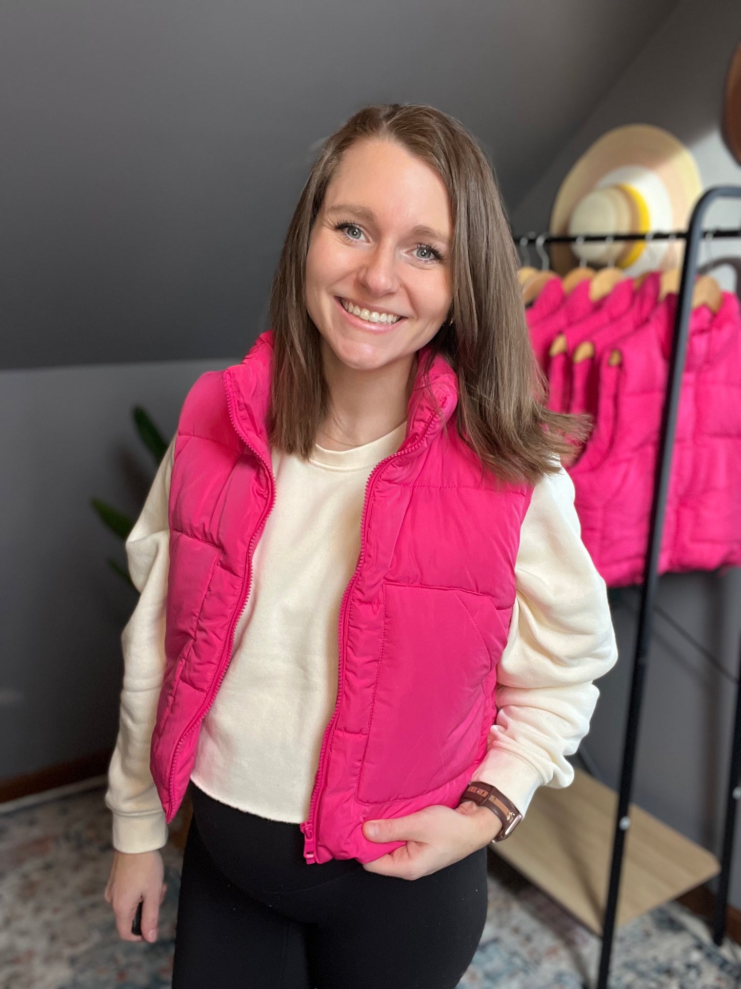 hot pink puffer vest with cream cropped sweatshirt