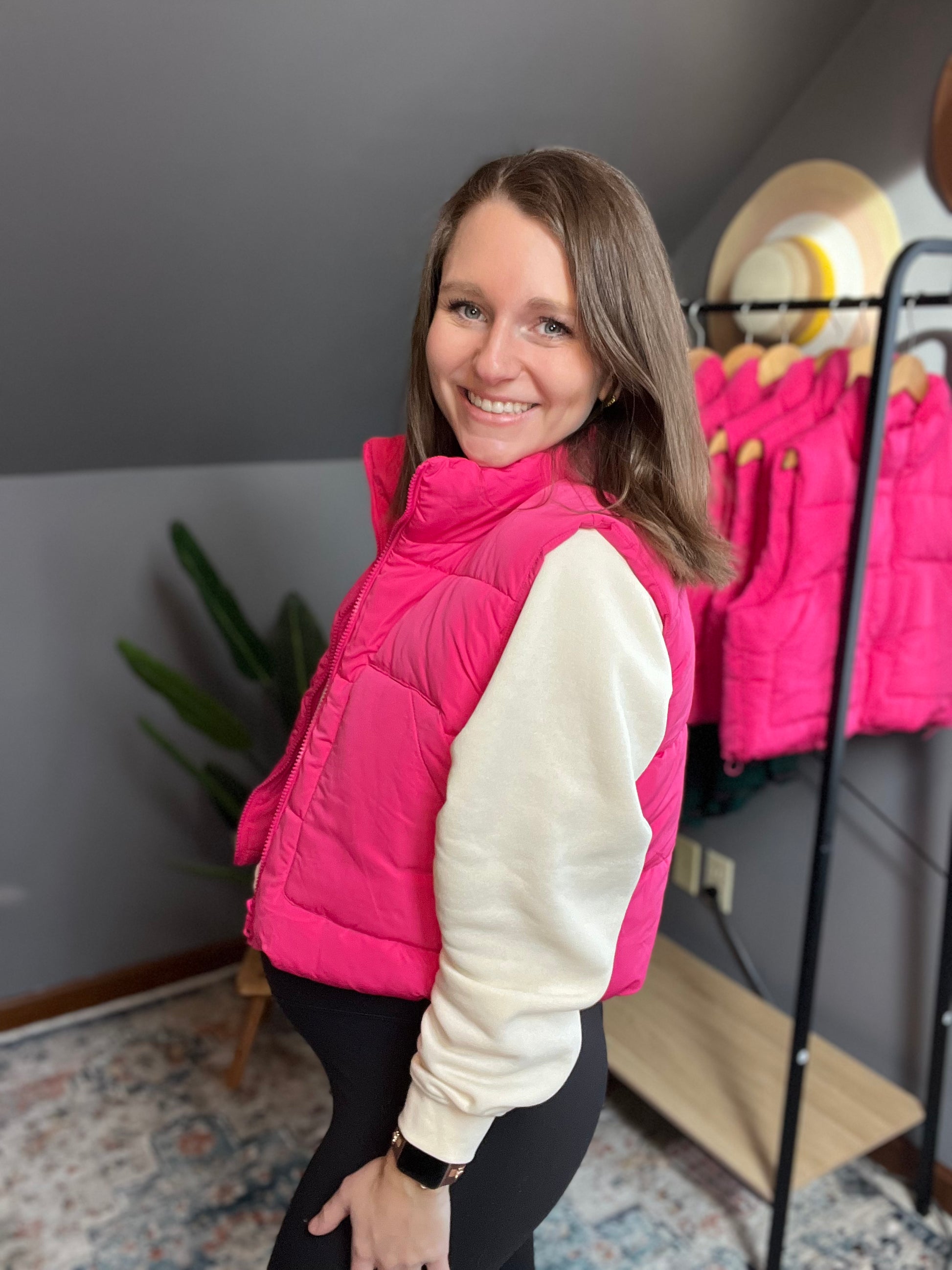 hot pink puffer vest with cream cropped sweatshirt