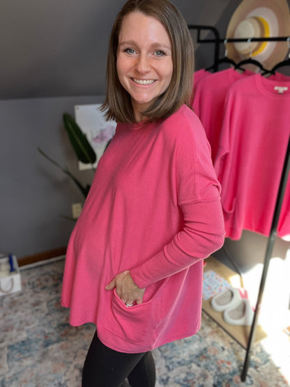 bubblegum pink oversized sweater with batwing sleeves and two pockets at the hip