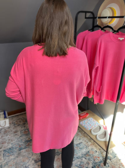 bubblegum pink oversized sweater with batwing sleeves and two pockets at the hip